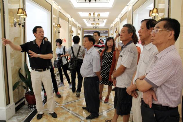 图3、宏陶市场总监霍达炎（左一）在为参观者介绍釉面砖展示空间.jpg